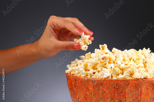 Photo: Woman's Hand and Popcorn Bowl Woman's Hand and Popcorn Bowl