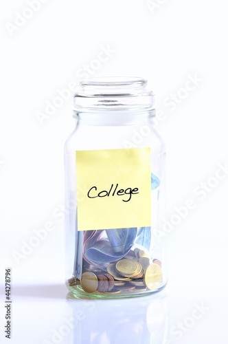 Photo: Glass jar with coins college. Glass jar with coins college.