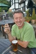 Man enjoying a cigar and pint