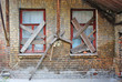 Old abandoned house brick wall with covered windows
