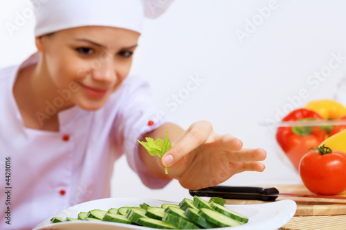 Foto: Young cook preparing food Young cook preparing food