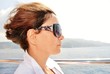 young woman with hair flying on the deck of ship