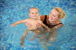Photo: Young mother and little son having fun in a swimming pool Young mother and little son having fun in a swimming pool