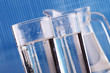 Composition with two glasses of water on blue background