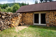 Dry firewoods well groomed in yard near a house