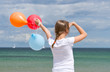 Photo: Girl at the Beach with colorful Balloons Girl at the Beach with colorful Balloons
