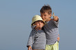 two young happy children in sailors t-shirt isolated over sky