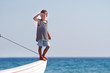 young boy in sailor shirt on board of sea yacht