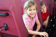 Photo: Smiling boy and girl look out from backs of seats in bus Smiling boy and girl look out from backs of seats in bus
