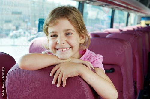 Photo: Closeup portrait of smiling girl on bus seat Closeup portrait of smiling girl on bus seat