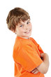 Smiling boy in orange t-shirt with folded arms stands