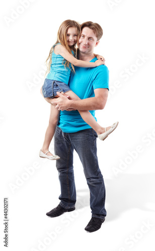 Photo: Father in blue shirt holds daughter on his hands Father in blue shirt holds daughter on his hands