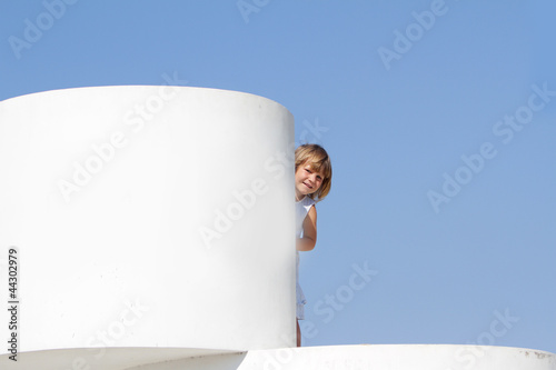 Photo: outdoor portrait of young happy girl hiding behind big white cub outdoor portrait of young happy girl hiding behind big white cub