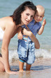 Photo: outdoor portrait of young happy mother and child on beach outdoor portrait of young happy mother and child on beach