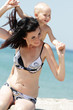 Photo: outdoor portrait of young happy mother and child on sea backgrou outdoor portrait of young happy mother and child on sea backgrou