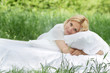 young beautiful woman relaxing on natural background