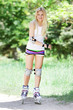 young beautiful happy woman on roller blades on natural backgrou