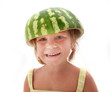 studio portrait of happy smiling child girl in watermelon hat is
