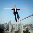 Balancing businessman and cityscape