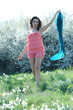 Photo: the girl with the pink dress plays with a blue ribbon in a flowe the girl with the pink dress plays with a blue ribbon in a flowe