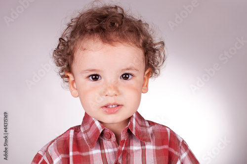 Photo: charming little boy trying to smile charming little boy trying to smile