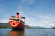 Abandoned red ship in the river