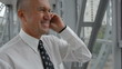Video: senior businessman standing and talking on cellphone senior businessman standing and talking on cellphone