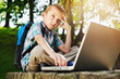 Thoughtful boy with laptop