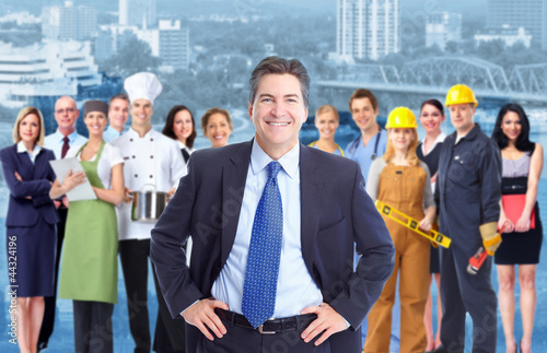 Photo: Businessman and Group of industrial workers. Businessman and Group of industrial workers.