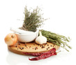 dried herbs in mortar and vegetables, isolatrd on white