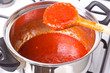 Foto: Wooden spoon in the pot with red sauce Wooden spoon in the pot with red sauce