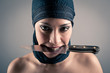 Photo: Veiled woman holding a knife against dark background. Intense po Veiled woman holding a knife against dark background. Intense po