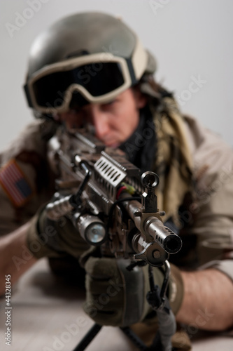 Photo: Soldier with rifle against white background. Soldier with rifle against white background.