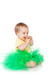 Cheerful little girl in a green skirt