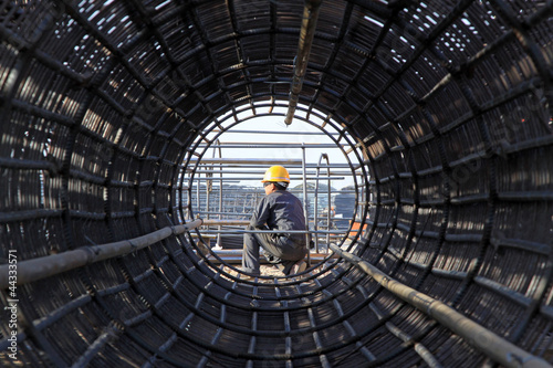 Photo: reinforced component at the construction site and workers reinforced component at the construction site and workers