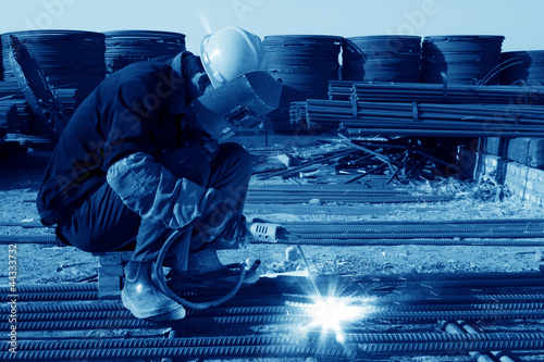 Photo: reinforced component at the construction site and workers reinforced component at the construction site and workers