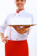 Cook holding an empty tray