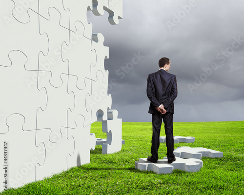 Photo: Businessman with a puzzle pieces Businessman with a puzzle pieces