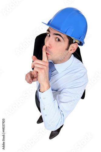 Photo: Engineer holding his finger to his lips Engineer holding his finger to his lips