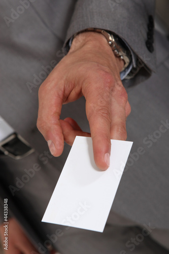 Photo: Executive handing out his business card Executive handing out his business card