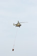 Russian military helicopter MI-8 extinguishes fire with water