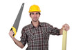 Carpenter holding hand saw