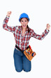 Triumphant female construction worker
