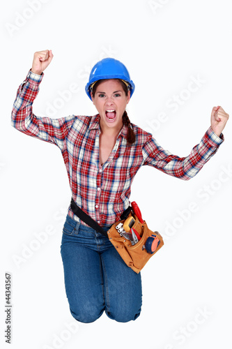 Photo: Triumphant female construction worker Triumphant female construction worker