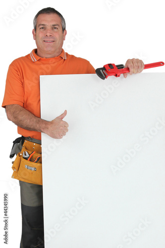 Photo: Plumber holding message board Plumber holding message board