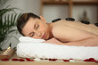 Woman with hot stones on back