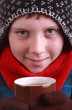 boy dressed for winter with hot drink