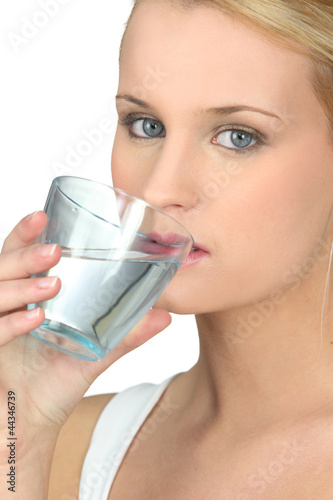 Photo: young woman drinking water young woman drinking water