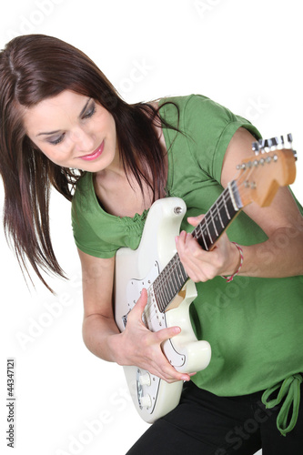 Photo: Young woman playing guitar Young woman playing guitar
