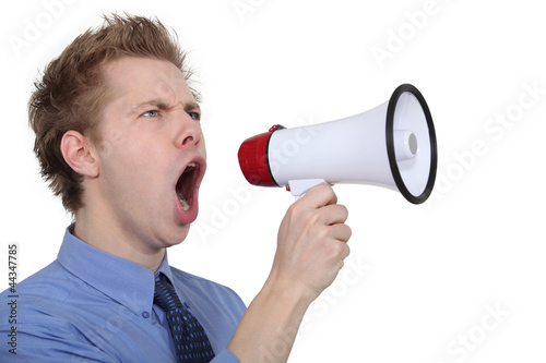 Photo: man shouting through a megaphone man shouting through a megaphone
